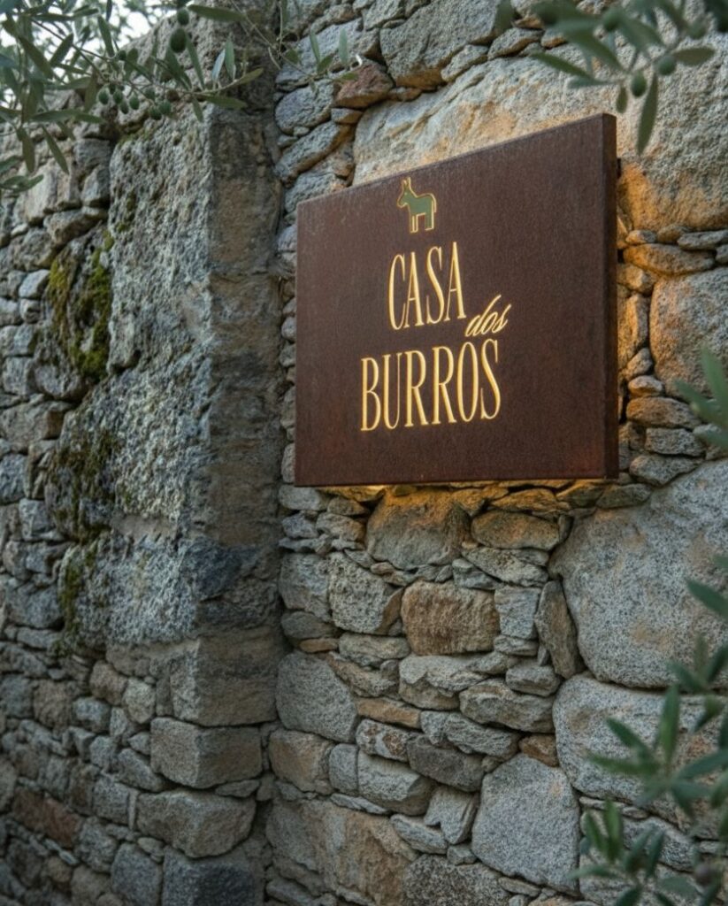 Placa da Casa dos Burros num muro de pedra